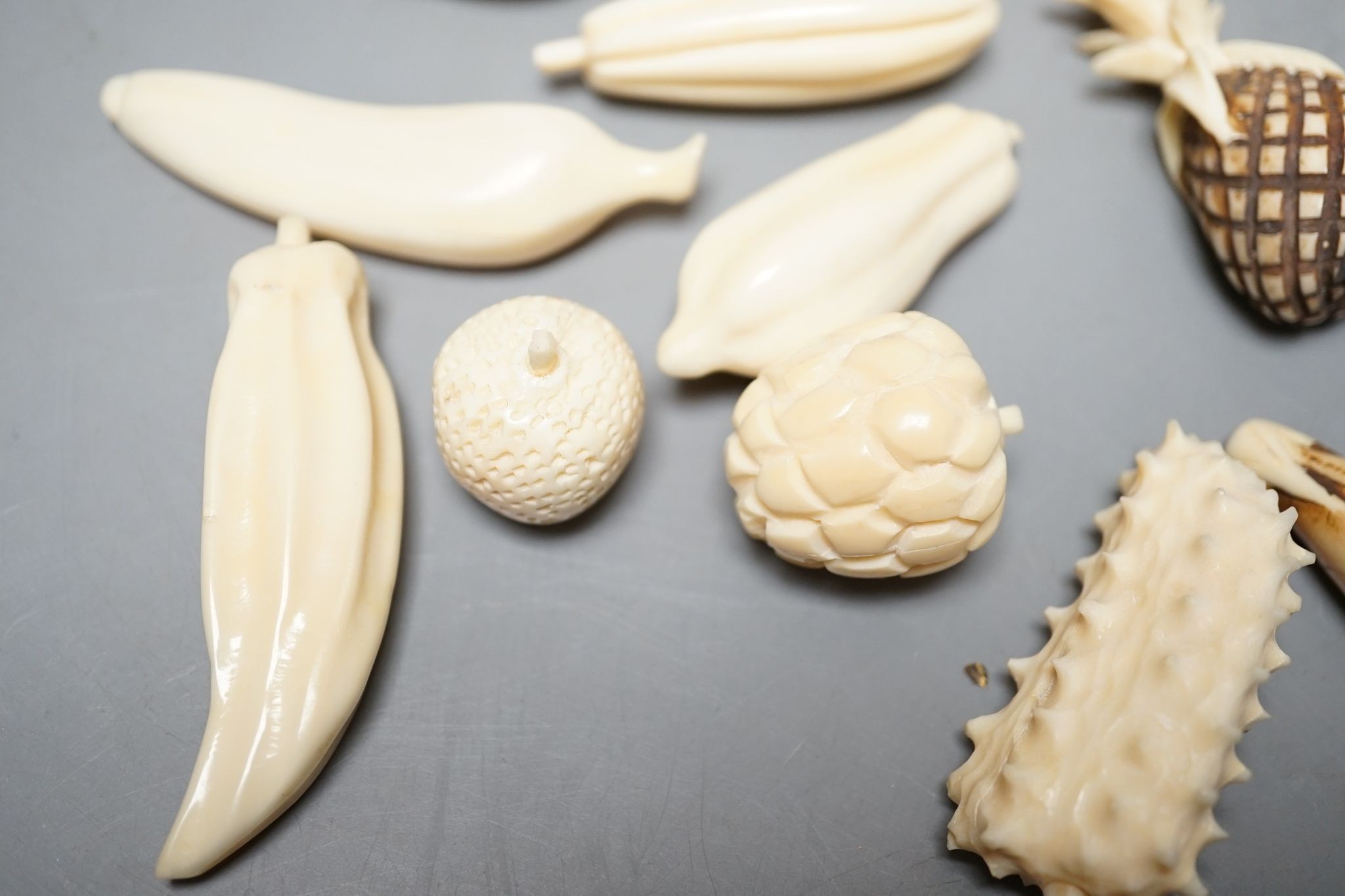 A group of Chinese carved ivory fruits, on ‘leaf’, 19cm
